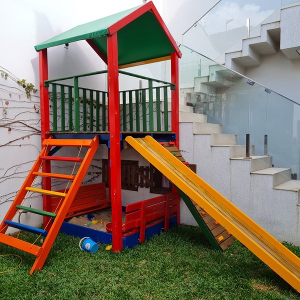 Parque infantil com casinha, balanço duplo e escorrega