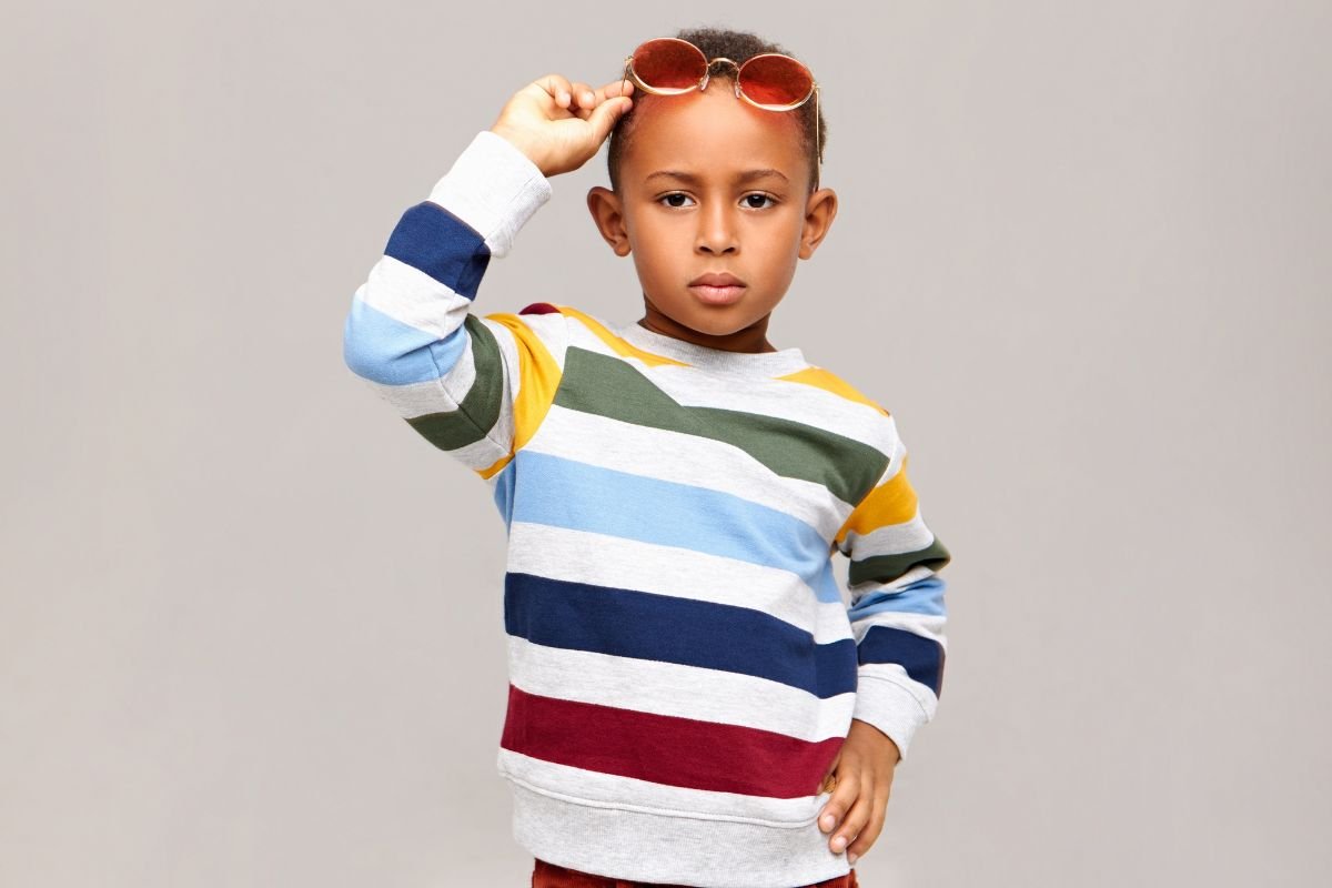 menino usando roupas coloridas e oculos vermelhos